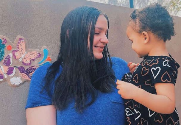 PHOTO: Chloe holds her older daughter at a tribute for her late daughter Laila, who died shortly after birth in September 2022. (Courtesy of Chloe)