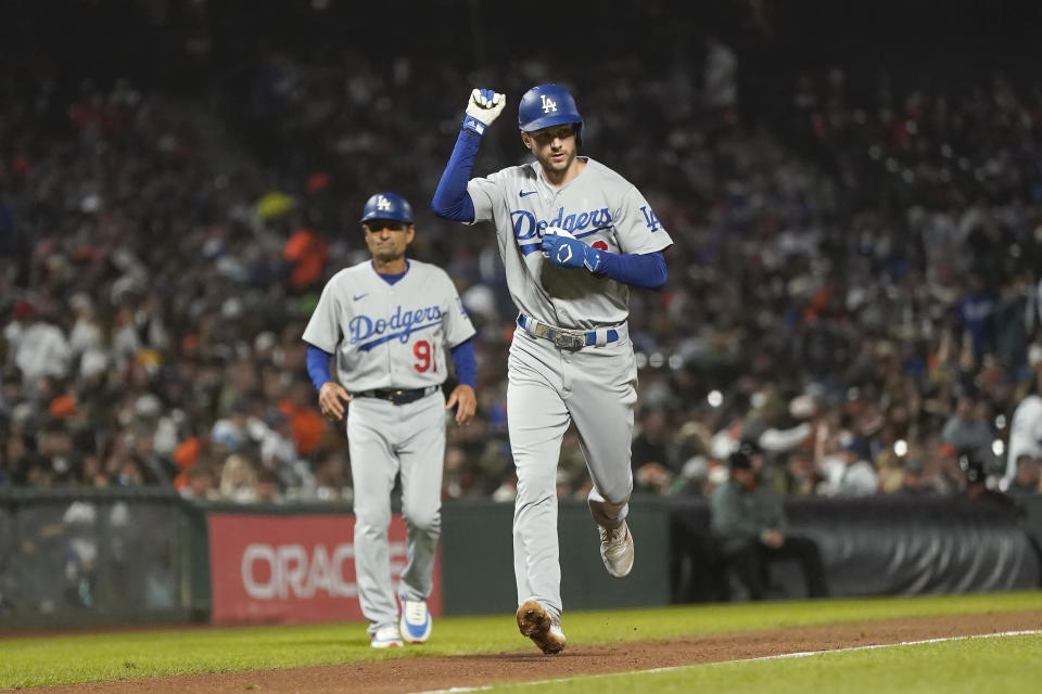 Los Angeles Dodgers' Trea Turner gestures in front of third base coach Dino Ebel (91) after hitting a home run against the San Francisco Giants during the seventh inning of a baseball game in San Francisco, Monday, Aug. 1, 2022. (AP Photo/Jeff Chiu)