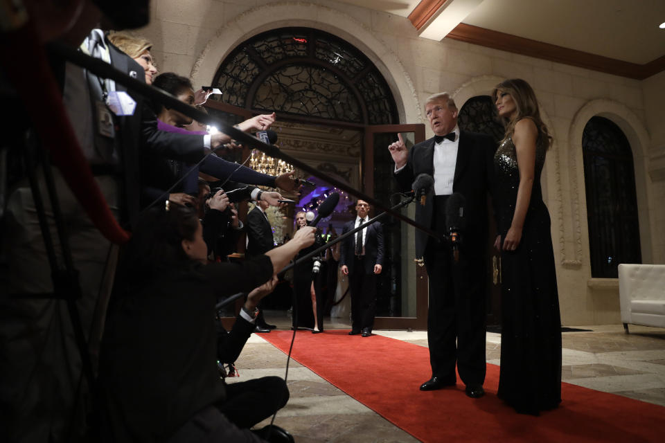 President Donald Trump speaks to the media about the situation at the U.S. embassy in Baghdad, from his Mar-a-Lago property, Tuesday, Dec. 31, 2019, in Palm Beach, Fla., as Melania Trump stands next to him. (AP Photo/ Evan Vucci)