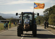 Demonstrators march along a highway near Girona, Spain, Wednesday, Oct. 16, 2019. Thousands of people have joined five large protest marches across Catalonia that are set to converge on Barcelona, as the restive region reels from two straight days of violent clashes between police and protesters. The marches set off from several Catalan towns and aimed to reach the Catalan capital by Friday. (AP Photo/Joan Mateu)