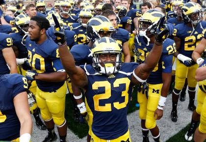 ANN ARBOR, MI - AUGUST 31: Dennis Norfleet #23 of the Michigan Wolverines celebrates a 59-9 win over the Central Michigan Chippewas with teammates at Michigan Stadium on August 31, 2013 in Ann Arbor, Michigan. (Photo by Gregory Shamus/Getty Images)