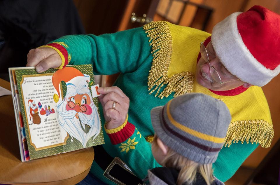 Vito Dash 5, listens as Raymond Durkee reads 'Twas the Night Before Christmas at the Canal Fulton VFW during the Christmas on the Canal celebration Saturday, Dec. 4, 2021