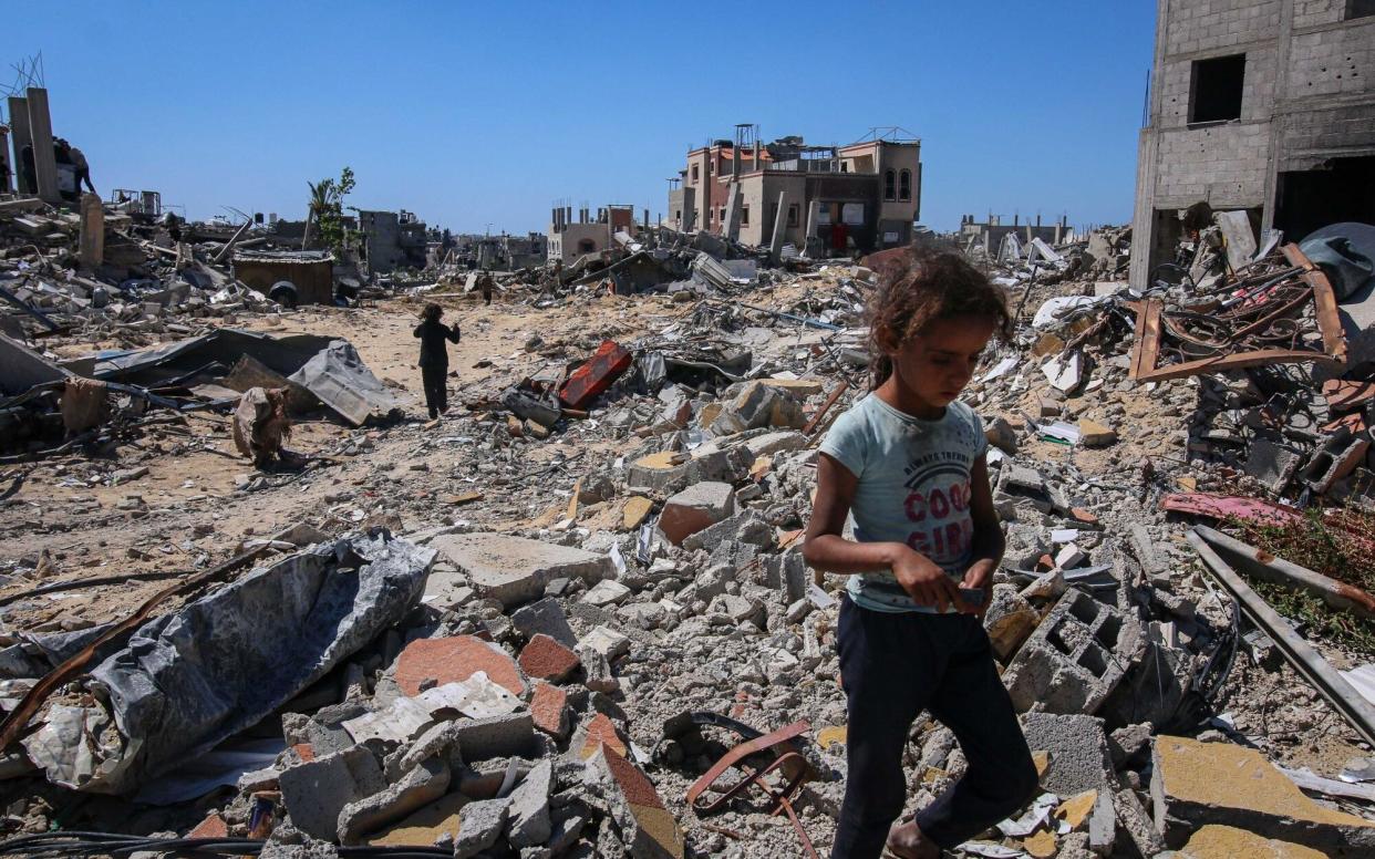 Displaced Palestinians inspect their destroyed homes after fleeing from Rafah