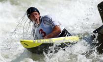 Tyler Hinton takes a breath after going under the water while competing in the men's C1 during the U.S. Olympic trials for whitewater slalom in Charlotte, North Carolina April 13, 2012.