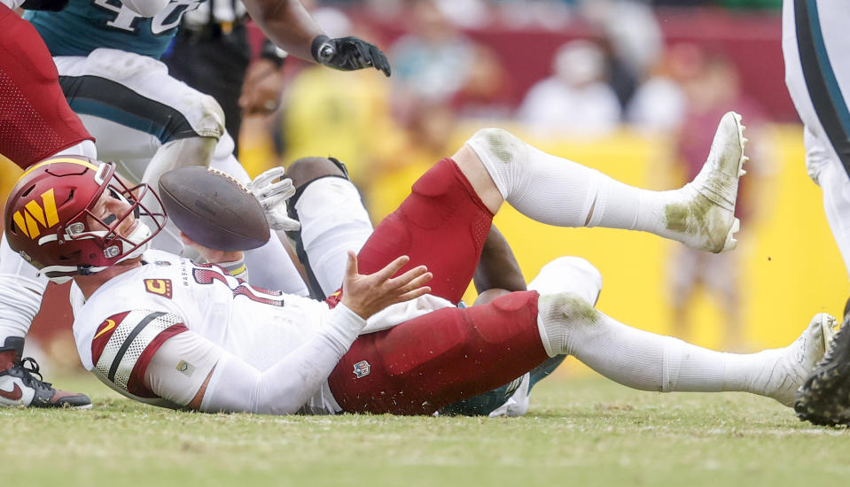 Philadelphia Eagles defensive end Josh Sweat (94) sacks Washington Commanders quarterback Carson Wentz (11) during the second half of a NFL football game between the Washington Commanders and the Philadelphia Eagles on Sunday, Sept. 25, 2022 at FedExField in Landover, Md. (Shaban Athuman/Richmond Times-Dispatch via AP)