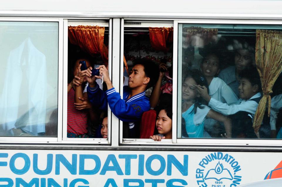 Spectators take photos of their favorite actresses and actors during the 2012 Metro Manila Film Festival Parade of Stars on 23 December 2012.(Angela Galia/NPPA Images)