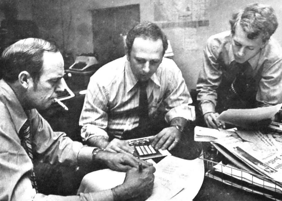 FILE - From left, Associated Press correspondent Rob Wood, photographer Lou Krasky, and staffer Rick Scott study a picture Krasky took of an electronic voting board as lawmakers in South Carolina voted to raise their expense allowances during a legislative session. Krasky, a long-time senior Associated Press photographer based in South Carolina, died Thursday, Feb. 8, 2024. (AP Photo)