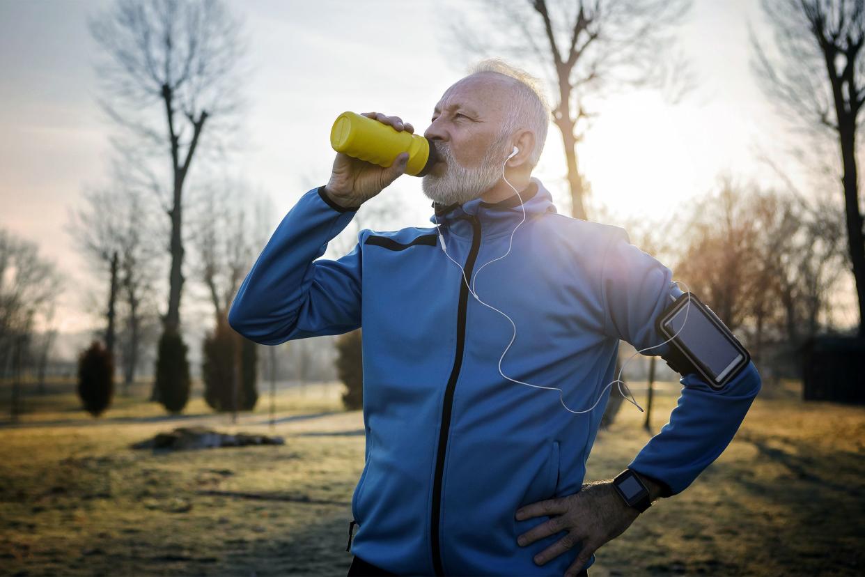 Active senior man drinking from a water bottle