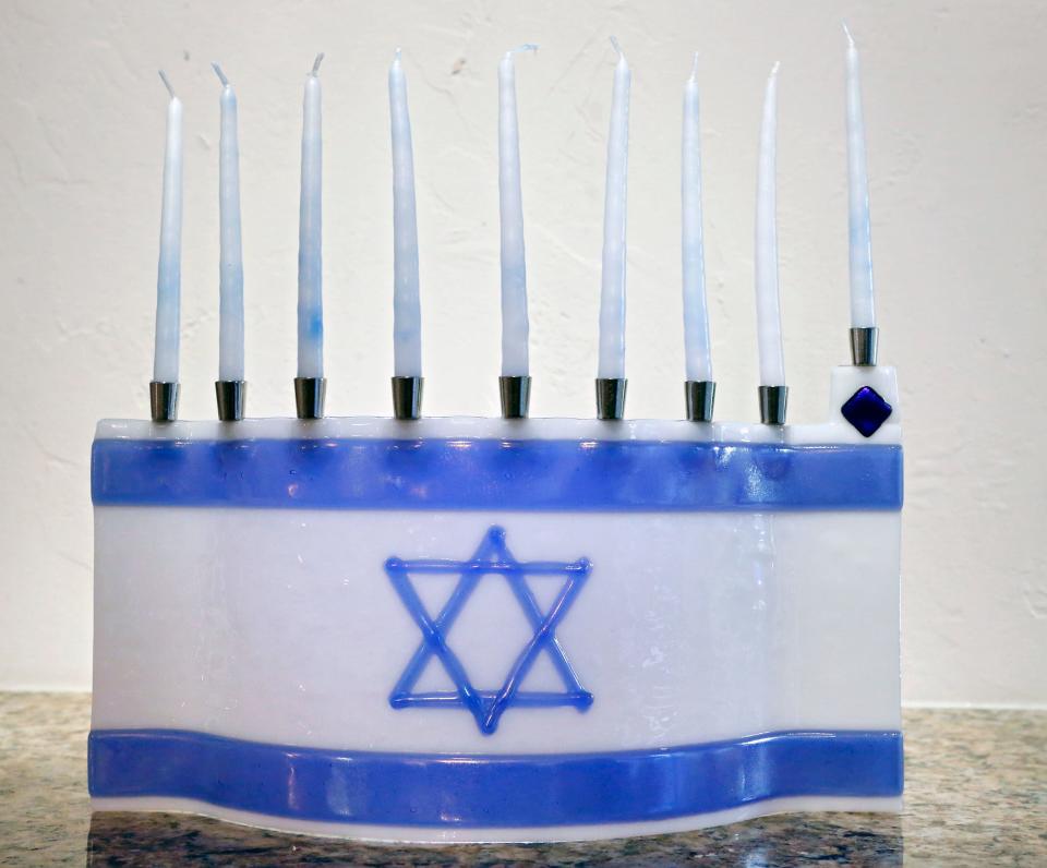 A menorah patterned after the Israeli flag is among Oklahoma City resident Sherry Barton's menorah collection. [THE OKLAHOMAN FILE]