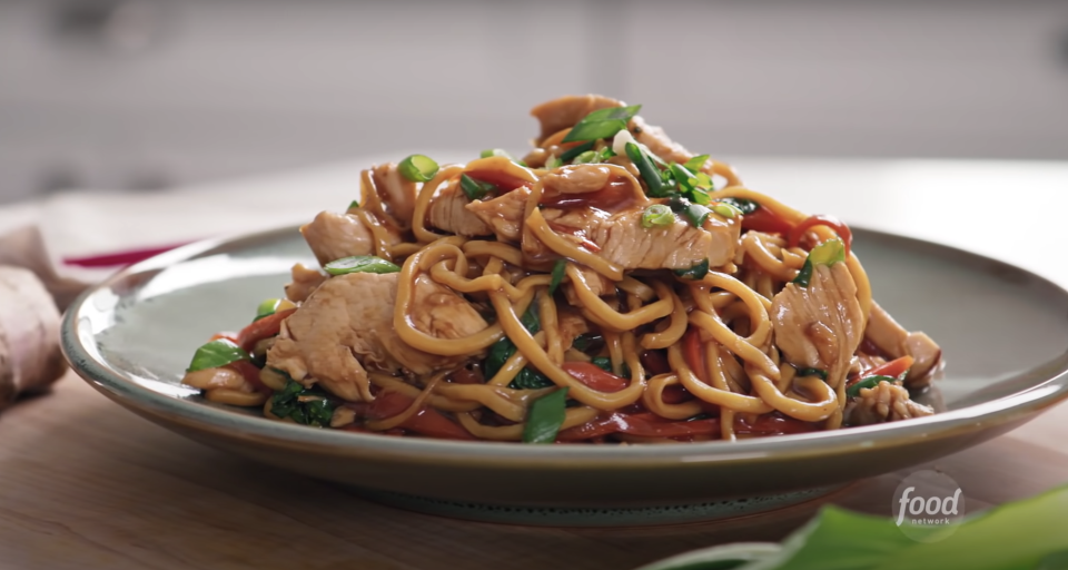 a plate of lo mein noodles and chicken