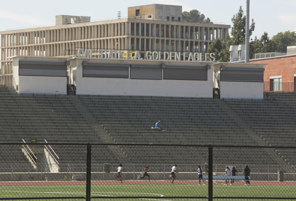 CORRECTS TO ORDER ISSUED LATE WEDNESDAY Students practice track at the Cal State University, Los Angeles campus Thursday, April 25, 2019. A quarantine order was issued late Wednesday for hundreds of students and staff at two Los Angeles universities, including Cal State University, who may have been exposed to measles and either have not been vaccinated or can't verify that they have immunity. (AP Photo/Damian Dovarganes)