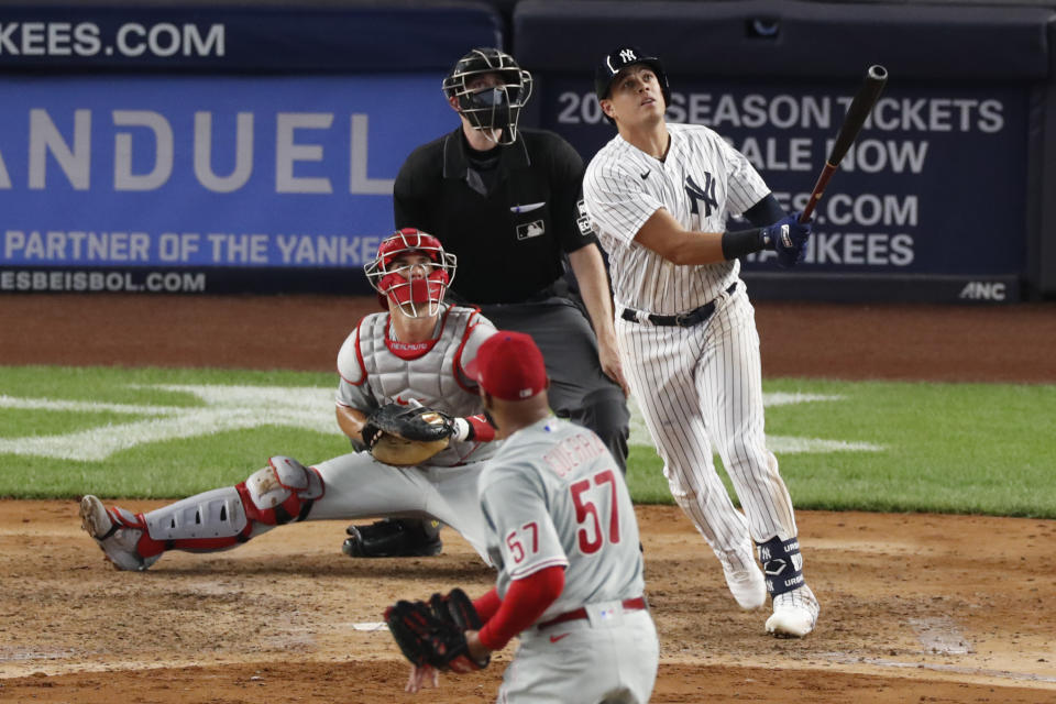 New York Yankees Gio Urshela, Philadelphia Phillies catcher J.T. Realmuto (10), and home plate umpire Nic Lentz watch Urshela's sixth-inning, three-run, home run off Phillies relief pitcher Deolis Guerra (57) in a baseball game, Monday, Aug. 3, 2020, at Yankee Stadium in New York. (AP Photo/Kathy Willens)