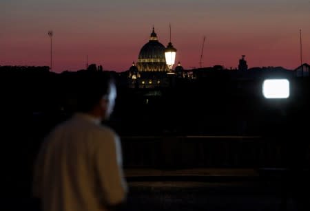 A member of the media waits outside the Quirinal palace in Rome