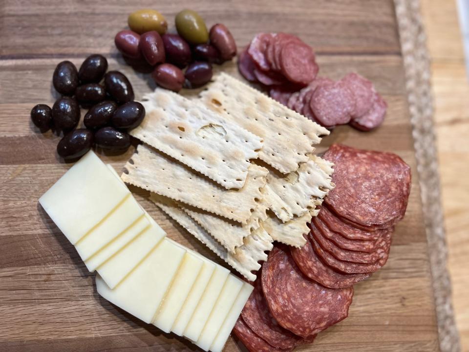 Charcuterie board contents on cutting board