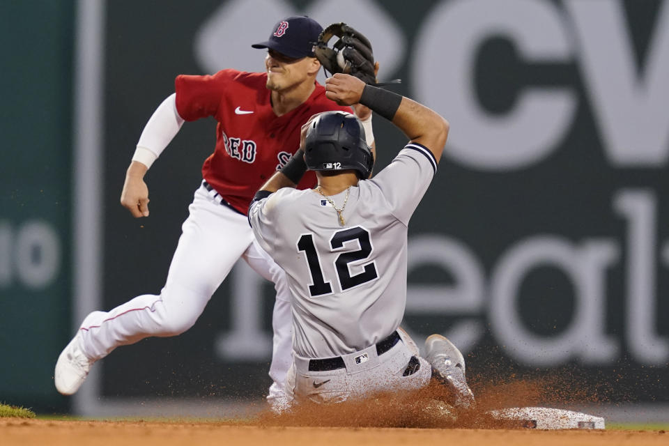 New York Yankees' Rougned Odor (12) slides, but is about to be tagged out while trying to steal second, as Boston Red Sox second baseman Enrique Hernandez catches the throw during the third inning of a baseball game at Fenway Park, Friday, July 23, 2021, in Boston. (AP Photo/Elise Amendola)