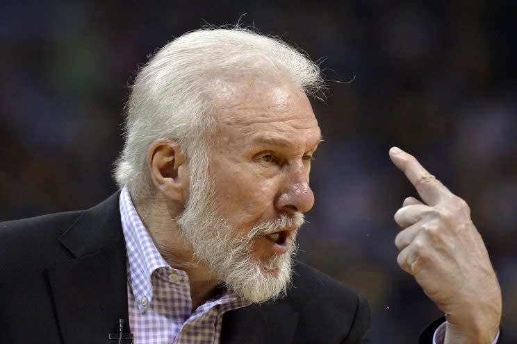 Gregg Popovich stares down another sideline reporter. (AP)