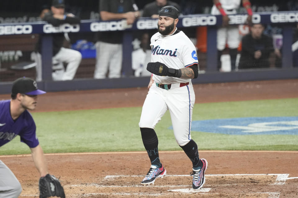 Miami Marlins' Emmanuel Rivera (15) scores on a hit by Luis Arraez during the fifth inning of a baseball game against the Colorado Rockies, Wednesday, May 1, 2024, in Miami. (AP Photo/Marta Lavandier)