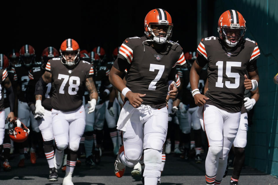 Cleveland Browns quarterbacks Jacoby Brissett (7) and Joshua Dobbs (15) enter the field before the start of an NFL football game against the Miami Dolphins, Sunday, Nov. 13, 2022, in Miami Gardens, Fla. (AP Photo/Lynne Sladky)