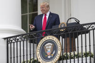 President Donald Trump points during a "Rolling to Remember Ceremony," to honor the nation's veterans and POW/MIA, from the Blue Room Balcony of the White House, Friday, May 22, 2020, in Washington. (AP Photo/Alex Brandon)