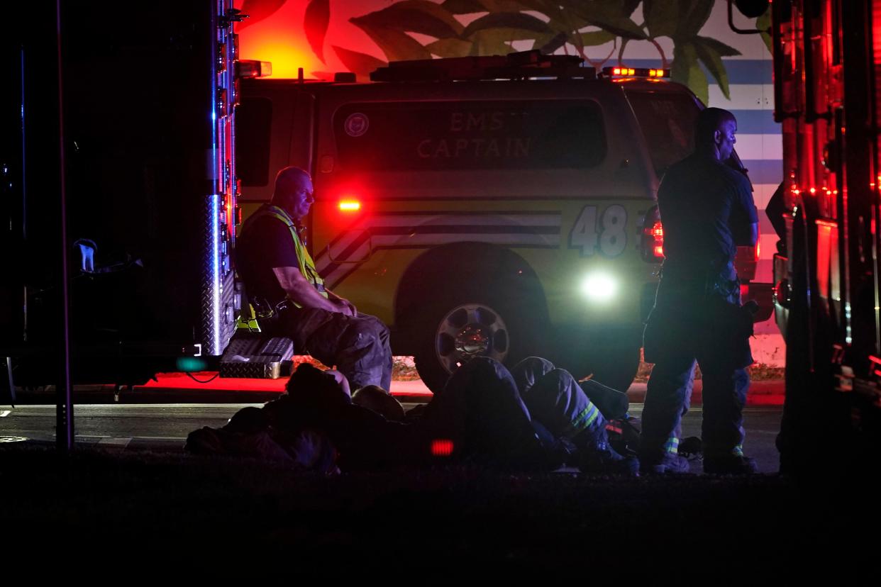 Firefighters stand by after part of a building collapsed, Thursday, June 24, 2021, in the Surfside area of Miami, Fla.