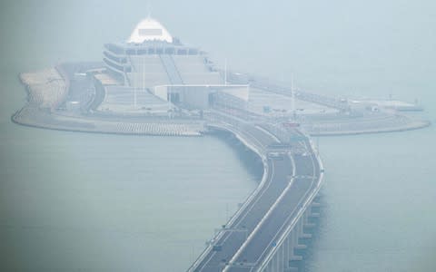 Cars park on a section of the Hong Kong-Zhuhai-Macau Bridge in front of the East Artificial Island in Hong Kong on October 23 - Credit: ANTHONY WALLACE/ AFP