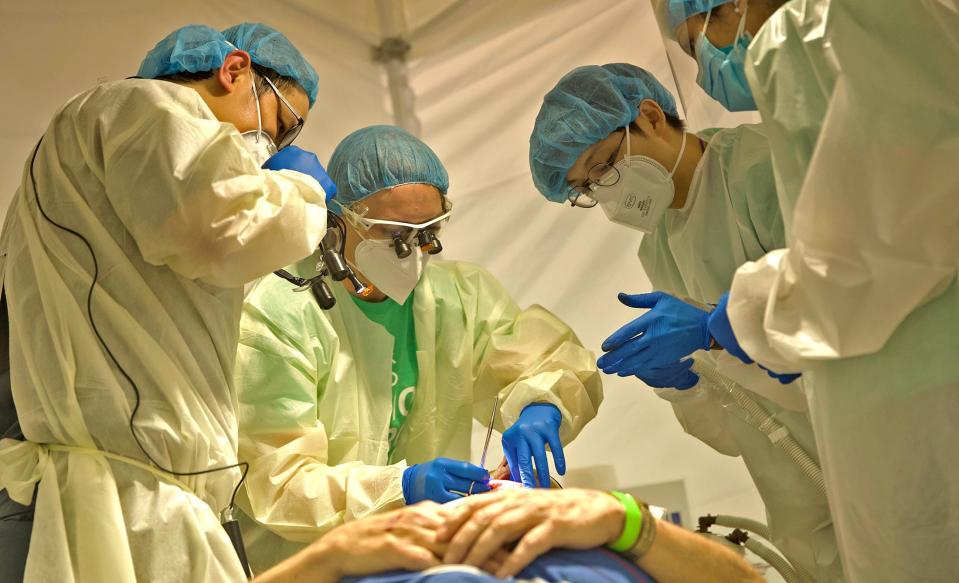 Medical staff work on patients during a free dental clinic at the First United Methodist Church on Saturday, June 5, 2021.