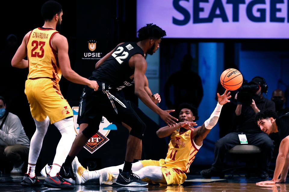 Iowa State's Tyrese Hunter (11) passes the ball away from Xavier's Dieonte Miles (22) during the first half of the NIT Season Tip-Off tournament on Wednesday in New York.