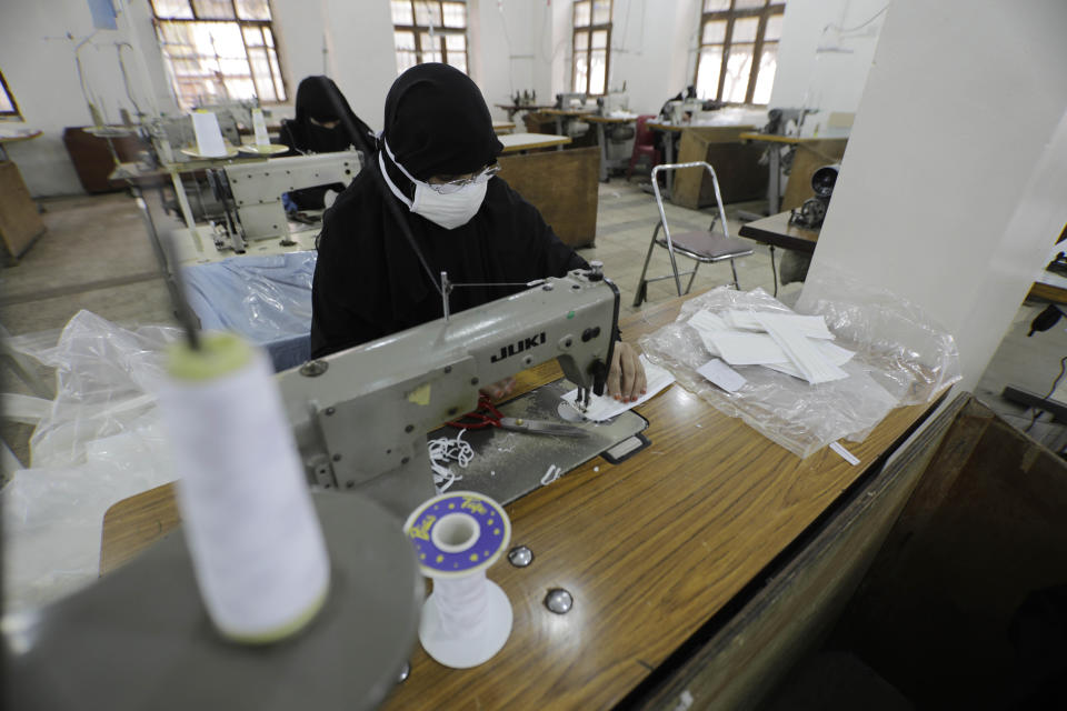 Yemeni women work to manufacture protective face masks, that are in high demand worldwide due the outbreak of the coronavirus, at a textile factory in Sanaa, Yemen, Tuesday, Mar. 17, 2020. For most people, the virus causes only mild or moderate symptoms. For some it can cause more severe illness. (AP Photo/Hani Mohammed)