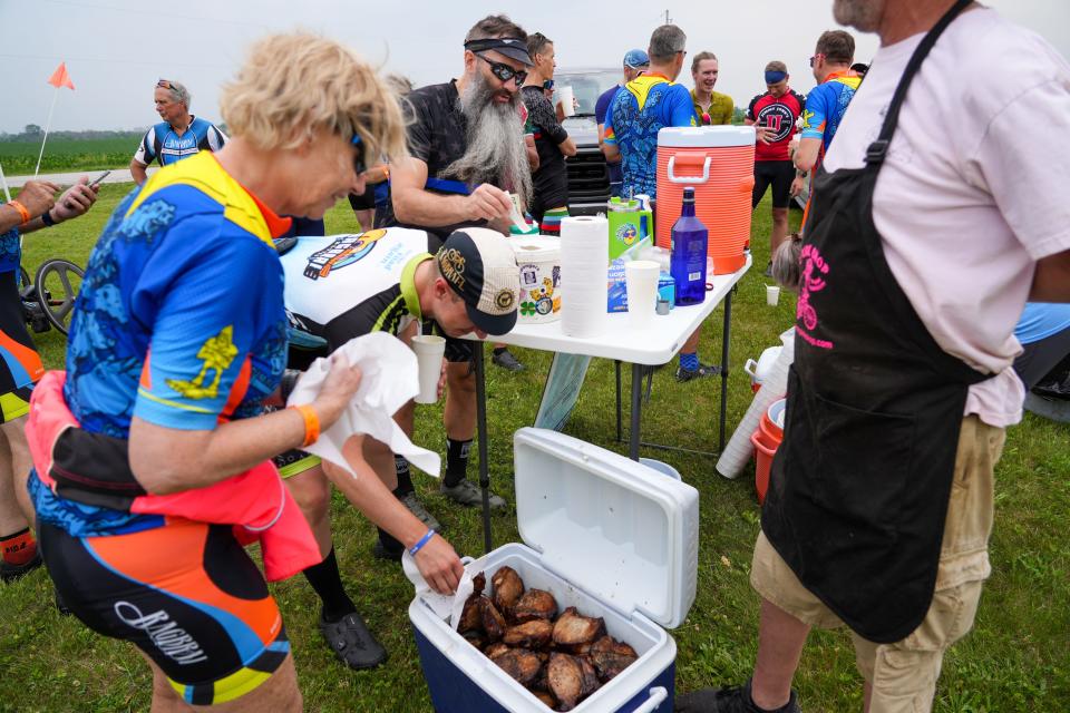 Riders stop for Mr. Pork Chop outside of Madrid during the RAGBRAI route inspection ride, Wednesday, June 7, 2023. 