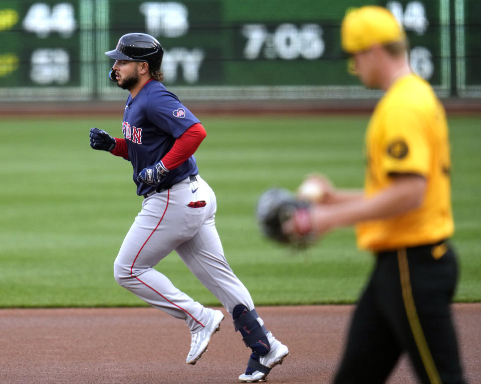 Boston Red Sox's Wilyer Abreu, left, rounds first base after hitting a solo home run off Pittsburgh Pirates starting pitcher Quinn Priester, right, during the first inning of a baseball game in Pittsburgh, Friday, April 19, 2024. (AP Photo/Gene J. Puskar)
