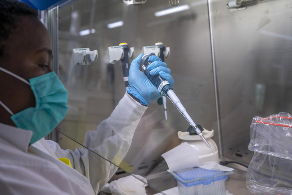 Puseletso Lesofi prepares to sequence COVID-19 omicron samples at the Ndlovu Research Center in Elandsdoorn, South Africa Wednesday Dec. 8, 2021. The centre ls part of the Network for Genomic Surveillance in South Africa, which discovered the omicron variant. (AP Photo/Jerome Delay)