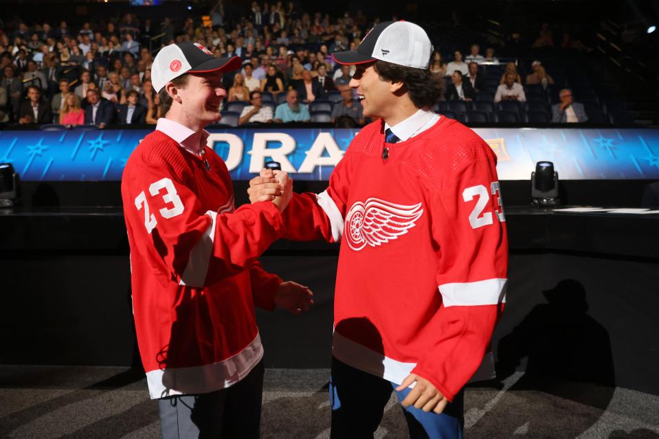 Trey Augustine, left, celebrates with Andrew Gibson after being selected by the Red Wings back-to-back during the NHL draft on Thursday, June 29, 2023, in Nashville, Tennessee.
