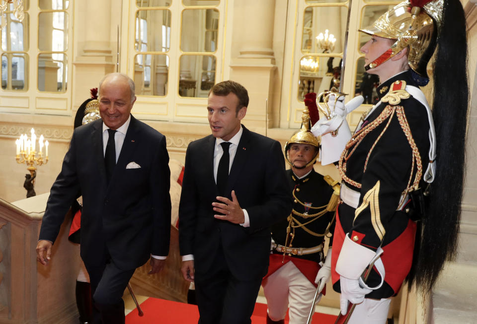 FILE -- French President Emmanuel Macron, center, and President of the French Constitutional Council Laurent Fabius, left, arrive at the Constitutional Council in Paris, Thursday Oct. 4, 2018 during a meeting to mark the 60th anniversary of the promulgation of the Constitution of the Fifth Republic. French unions have staged Thursday April 13, 2023 a new round of nationwide protests, one day before an expected ruling of the country's top constitutional body they hope will bring a halt to President Emmanuel Macron's unpopular pension plan. (Thomas Sampson, Pool via AP, File)