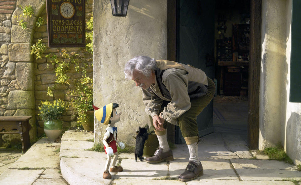 This image released by Disney shows Pinocchio, voiced by Benjamin Evan Ainsworth, left, and Tom Hanks as Geppetto in Disney's live-action film "Pinocchio." (Disney via AP)