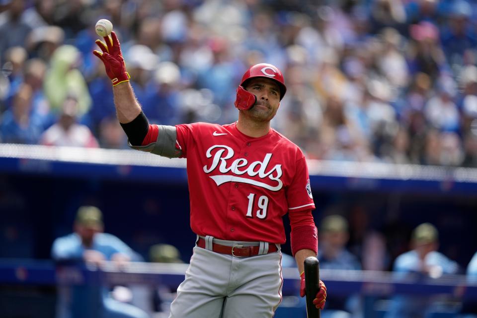 Cincinnati Reds' Joey Votto tosses the ball after catching his own foul tip off the screen during eighth-inning baseball game action against the Toronto Blue Jays in Toronto, Sunday, May 22, 2022. (Frank Gunn/The Canadian Press via AP)