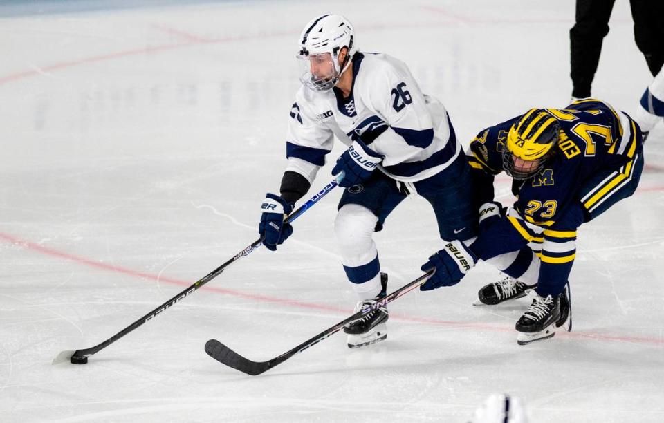 Penn State’s Ashton Calder skates down the ice with the puck ahead of Michigan’s Ethan Edwards during the game on Friday, Nov. 4, 2022 at Pegula Ice Arena. .