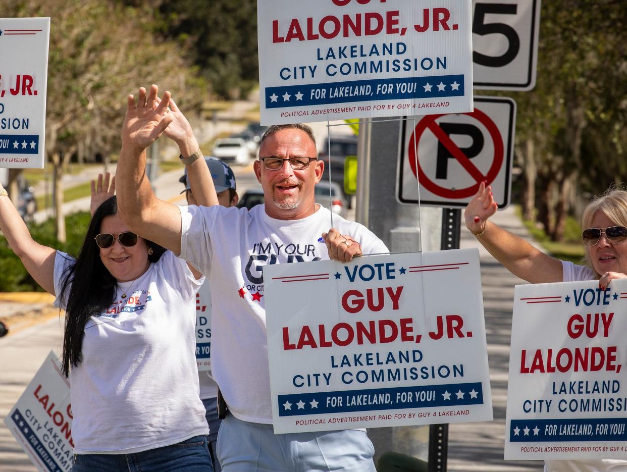 Lakeland City Commission candidate Guy Lalonde Jr. and supporters wave to traffic as they campaign along Edgewood Drive near Cleveland Heights Golf and Country Club in Lakeland Fl.. Tuesday November 7,2023.
Ernst Peters/The Ledger