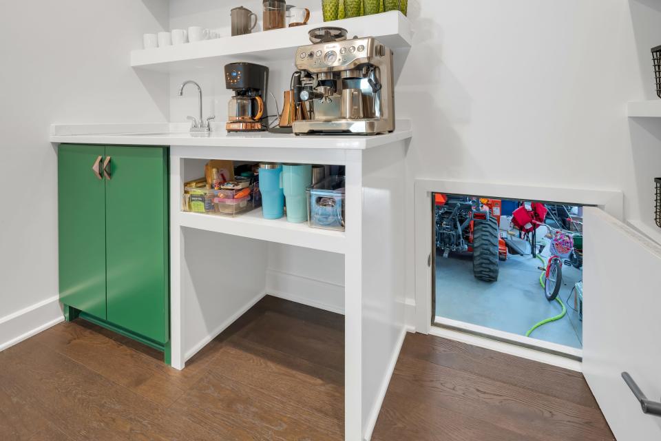 A Costco door in the hidden pantry makes it easy to transport groceries from the car to the house in this modern farmhouse-style home built by the Eldridge Company in Louisville.