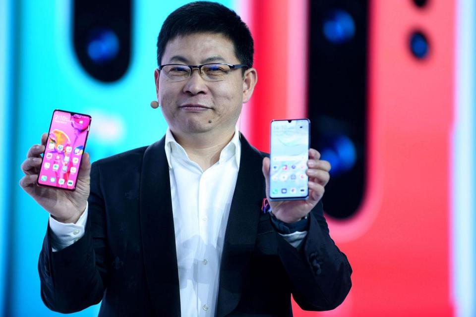 Huawei's head of consumer Richard Yu with the latest Huawei P30 Pro phones (ERIC PIERMONT / Contributor)