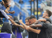 CF Montreal's Matko Miljevic, pumping fist facing camera, celebrates with fans and teammates after scoring against the Philadelphia Union during the first half of an MLS soccer game, Saturday, Oct. 16, 2021, in Montreal. (Graham Hughes/The Canadian Press via AP)