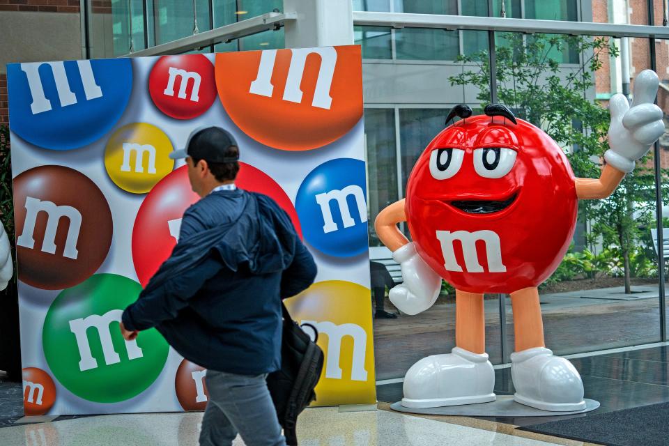 An M&M character greets conventioneers during The Sweet & Snacks Expo, Tuesday, May 14, 2024 at the Indiana Convention Center.
