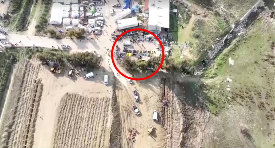 Dozens of bodybags could be seen waiting for a grave at a mass burial site. Source: Reuters