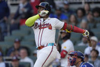 Atlanta Braves designated hitter Marcell Ozuna (20) follows through on a three-run home run as Texas Rangers catcher Andrew Knizner (12) looks on in the first inning of a baseball game Sunday, April 21, 2024, in Atlanta. (AP Photo/John Bazemore)