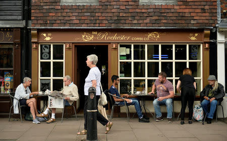 People sit outside a coffee shop in Rochester, Britain, August 8, 2017. REUTERS/Hannah McKay