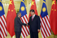 Chinese Premier Xi Jinping, right, shakes hands with Malaysian Prime Minister Mahathir Mohamad before a bilateral meeting of the Second Belt and Road Forum at the Great Hall of the People on Thursday, April 25, 2019 in Beijing, China. (Andrea Verdelli/Pool Photo via AP)