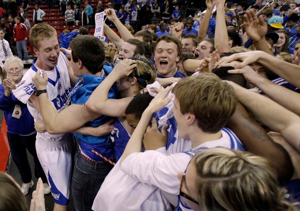 Whitefish Bay's Jamie Schneck is greeted by fans after beating  Seymour  during the 2011 WIAA state basketball tournament at the Kohl Center.