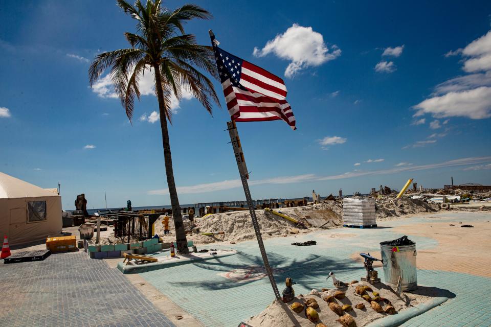 An American flag stands tall in Times Square on Fort Myers Beach on  Saturday, October 8, 2022. Hurricane Ian basically wiped Times Square off the map.  