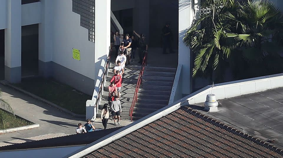 Students are escorted from the building. Source: Getty