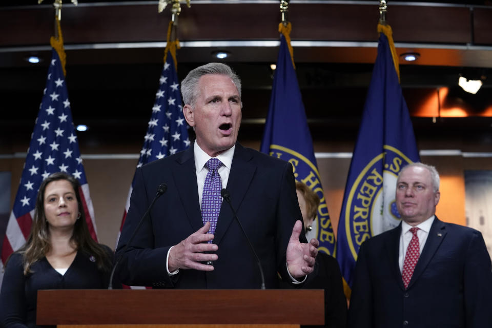 Rep. Kevin McCarthy at the podium with Rep. Elise Stefanik and Rep. Steve Scalise beside him.