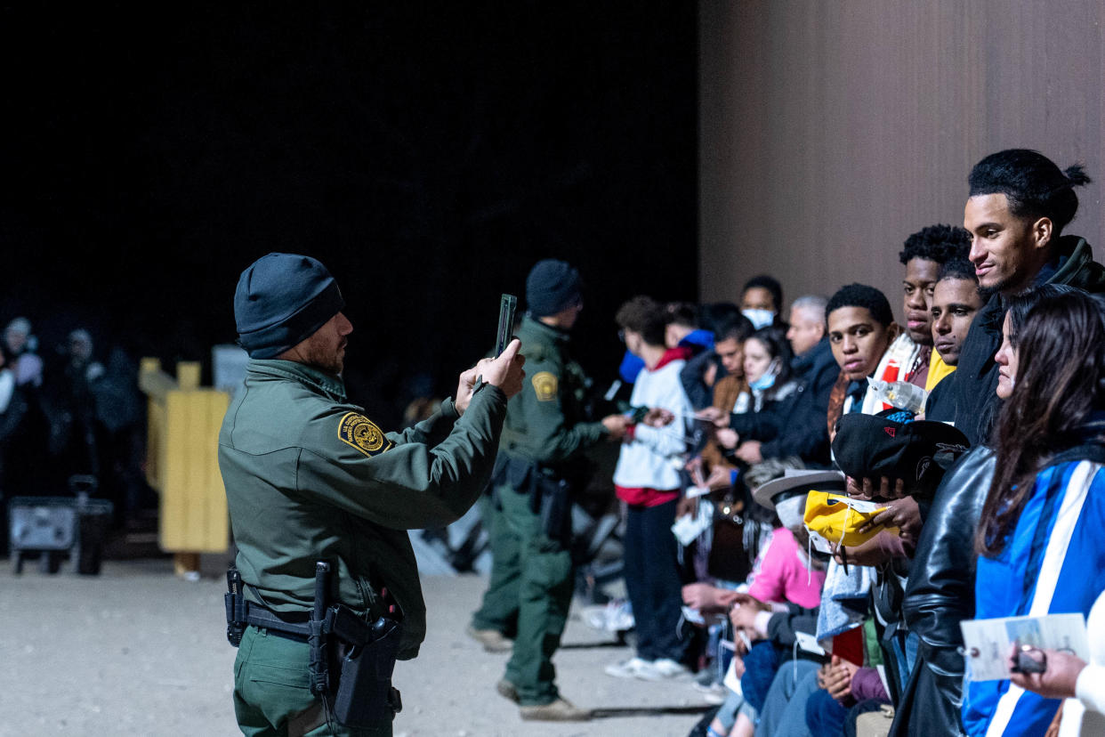 Migrants and asylum seekers are detained by U.S. Border Patrol agents after crossing the U.S.-Mexico border in Yuma County, near the Cocopah Indian Tribe's reservation on Dec. 8, 2022. Border Patrol agents estimated the group to be about 700 people.